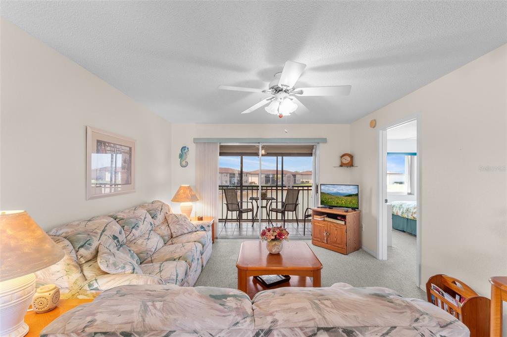 25100 Sandhill Boulevard, Unit R202 Punta Gorda, FL 33983 - Photo 8 of 39 a living room with furniture fireplace and a large window