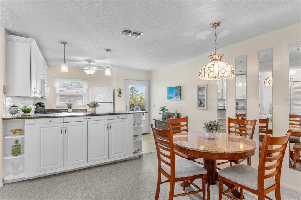 25100 Sandhill Boulevard, Unit R202 Punta Gorda, FL 33983 - Photo 10 of 39 a dining room with furniture and window