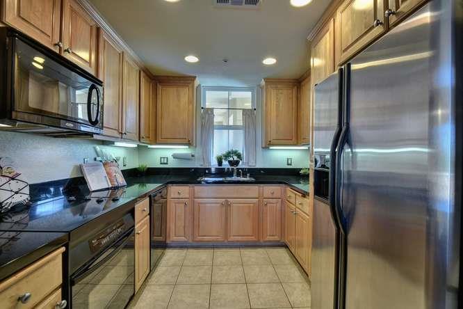 1310 Saddle Rack Street, Unit 438 San Jose, CA 95126 - Photo 7 of 18 a kitchen with stainless steel appliances granite countertop a refrigerator a stove and a sink