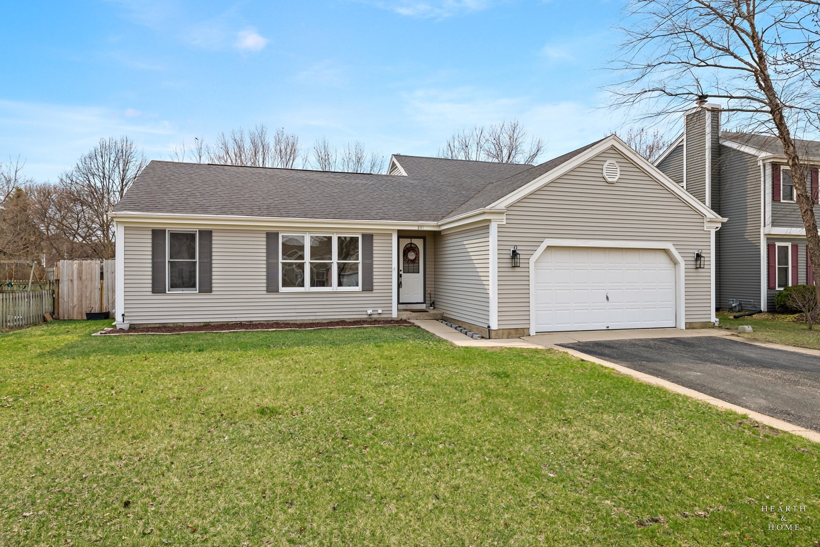 831 Chestnut Court Marengo, IL 60152 - Photo 1 of 29 a view of a yard in front of a house with large trees