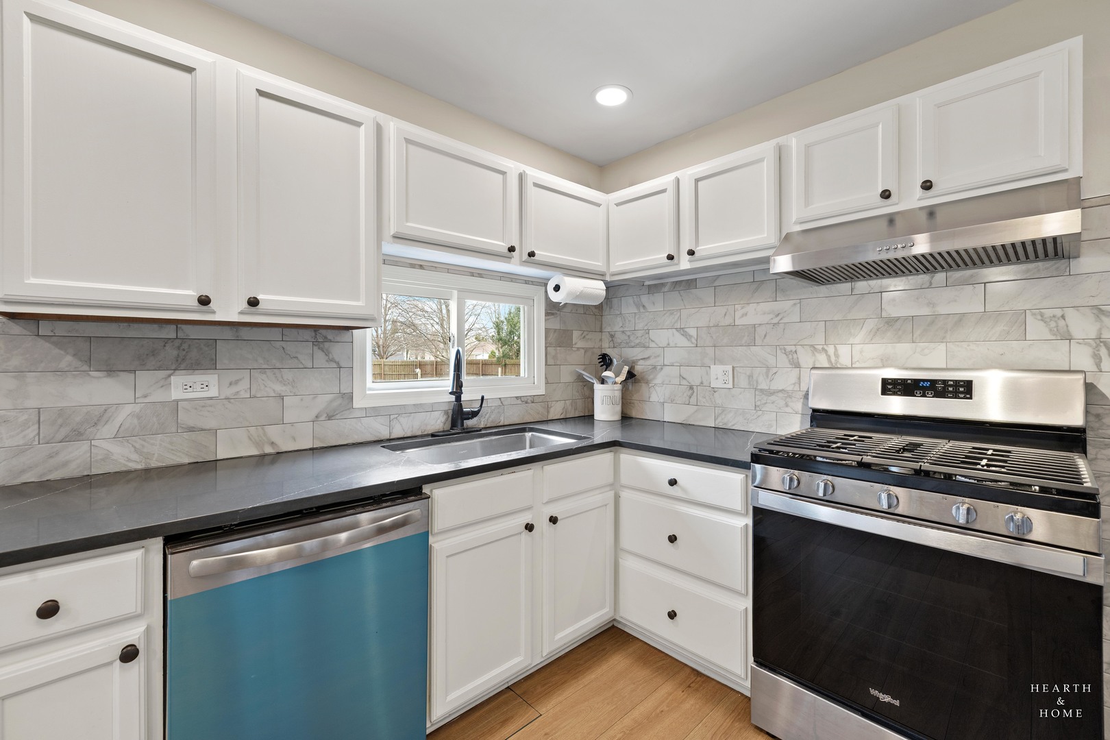 831 Chestnut Court Marengo, IL 60152 - Photo 11 of 29 a kitchen with white cabinets and appliances