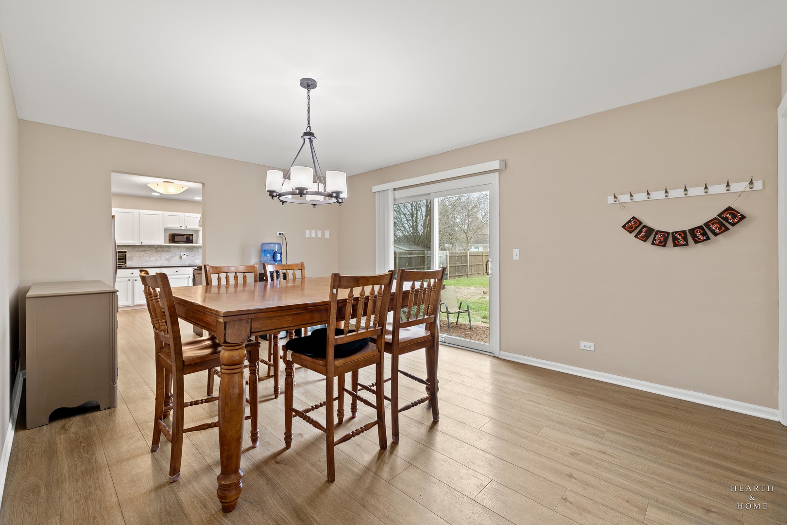 831 Chestnut Court Marengo, IL 60152 - Photo 6 of 29 a dining room with furniture a chandelier and wooden floor
