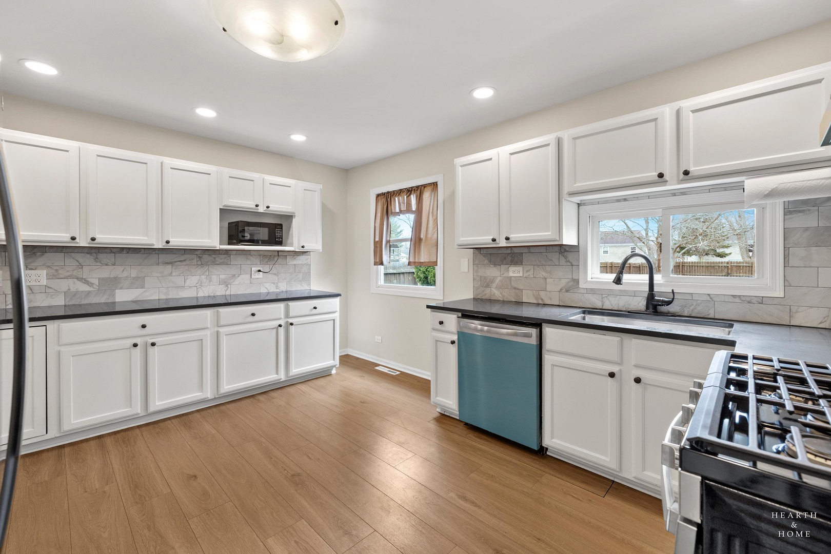 831 Chestnut Court Marengo, IL 60152 - Photo 8 of 29 a kitchen with kitchen island granite countertop a stove sink and cabinets