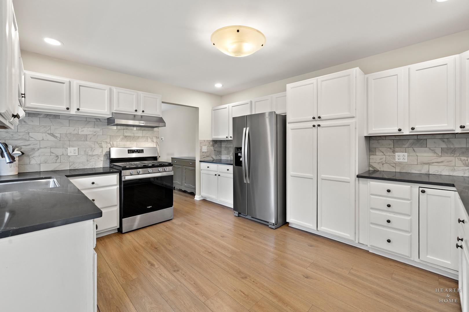 831 Chestnut Court Marengo, IL 60152 - Photo 9 of 29 a kitchen with granite countertop a refrigerator and a stove top oven
