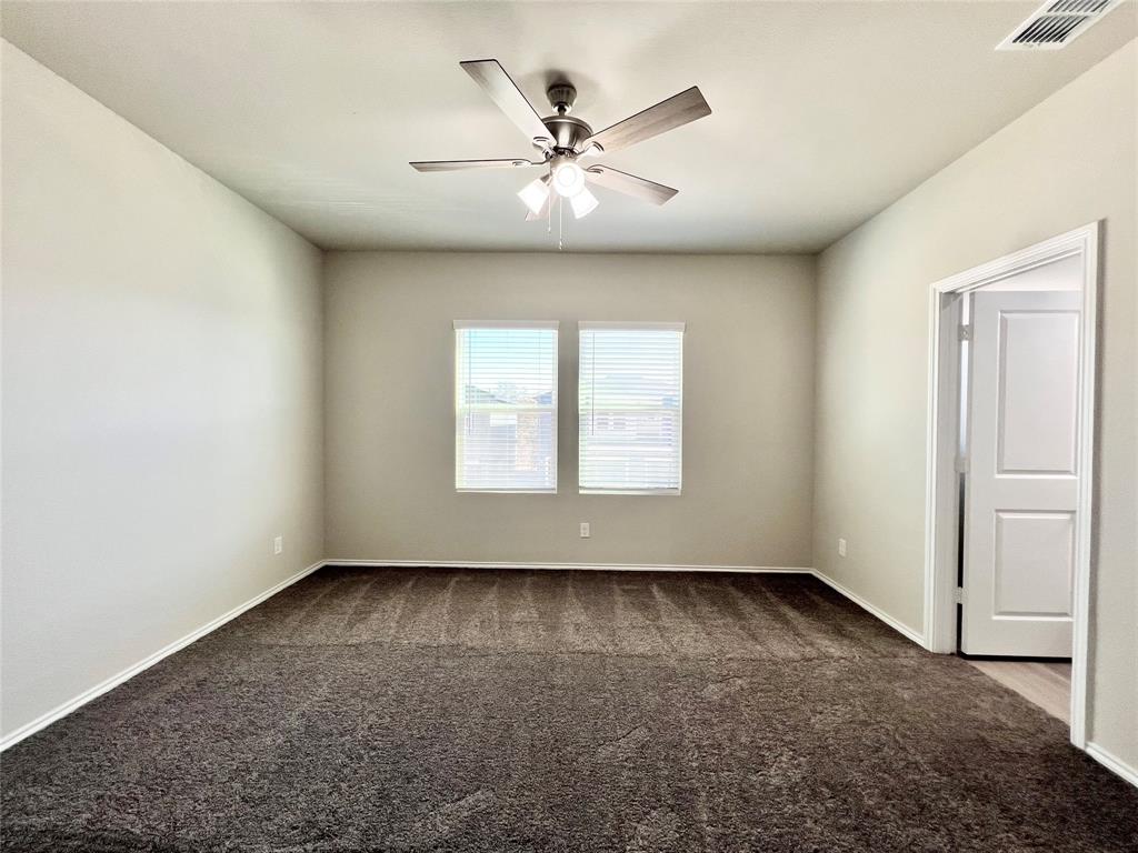 3501 East Renfro Street, Unit 106 Burleson, TX 76028 - Photo 18 of 32 an empty room with windows and fan
