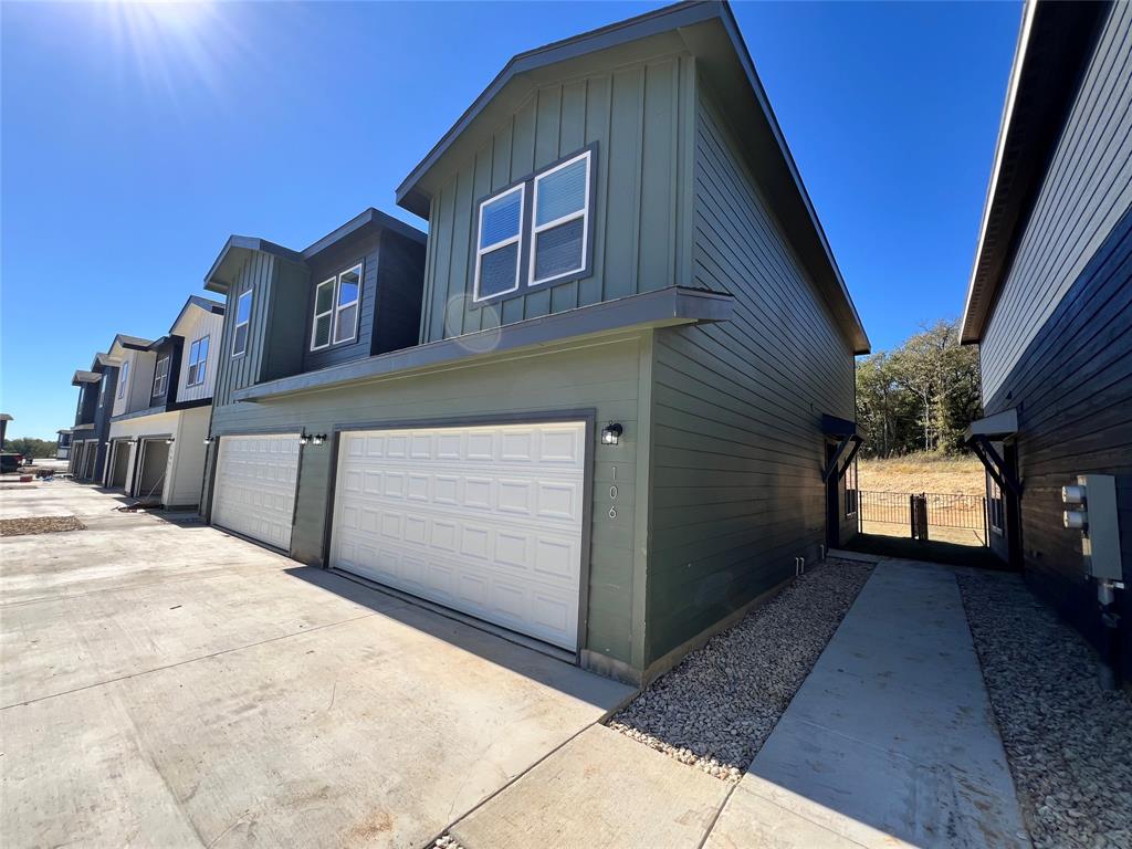 3501 East Renfro Street, Unit 106 Burleson, TX 76028 - Photo 2 of 32 a front view of a house with a yard