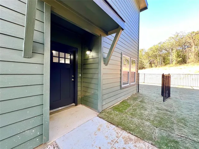 a view of a house with a wooden fence