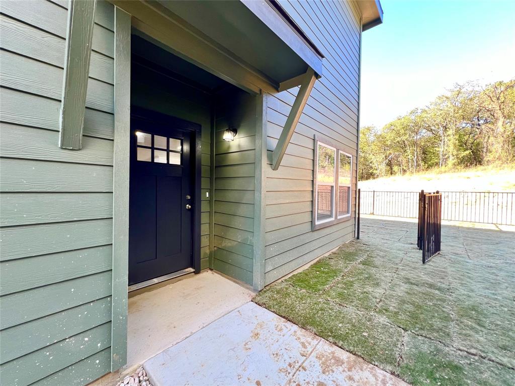 3501 East Renfro Street, Unit 106 Burleson, TX 76028 - Photo 3 of 32 a view of a house with a wooden fence
