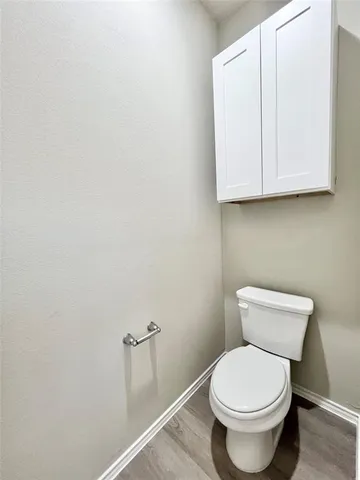 a white toilet sitting next to a bathroom sink