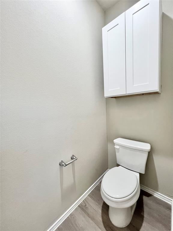 3501 East Renfro Street, Unit 106 Burleson, TX 76028 - Photo 32 of 32 a white toilet sitting next to a bathroom sink
