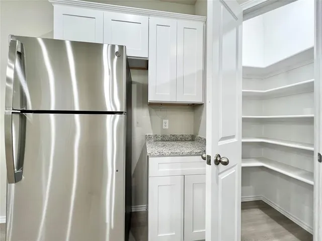 a white refrigerator freezer sitting in a kitchen