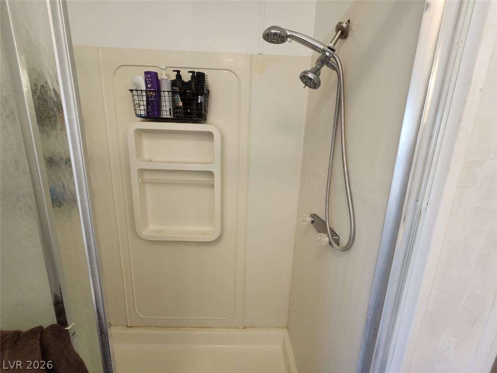 942 Holt Caliente, NV 89008 - Photo 18 of 22 A well-maintained shower with a convenient handheld showerhead.