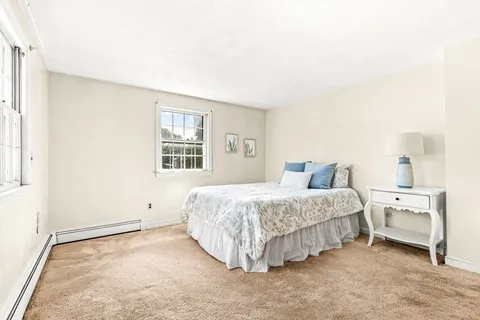 a spacious bedroom with a bed and a window