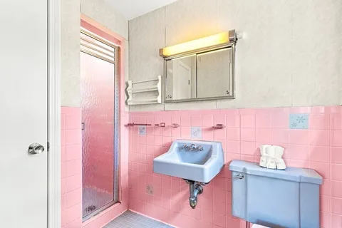 a bathroom with a sink a mirror and a toilet