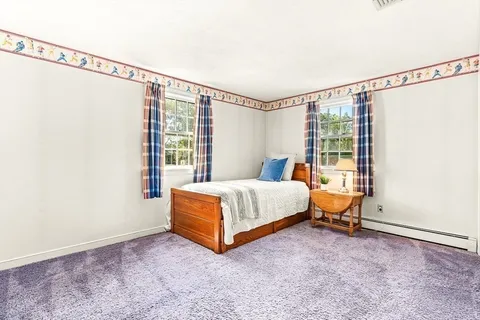 a bed sitting in a room next to a window