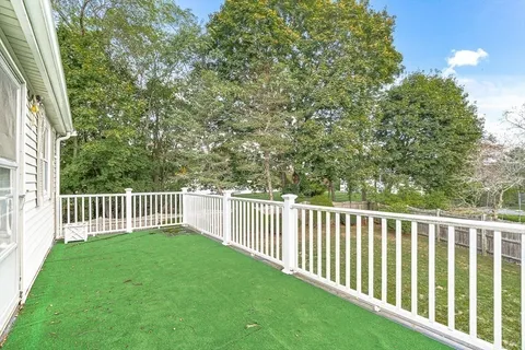 a balcony with view of a yard
