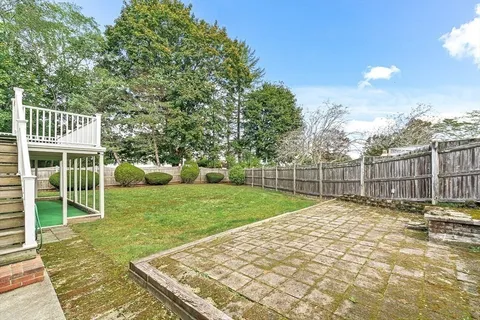 a view of a backyard with a garden and entertaining space
