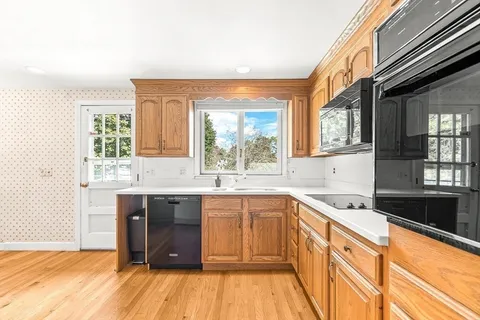 a kitchen with a sink stove and cabinets