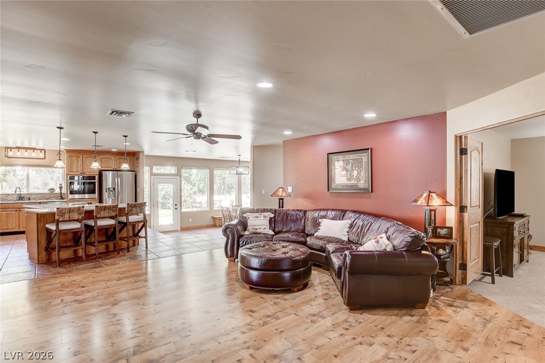 1950 Bowman Road Logandale, NV 89021 - Photo 80 of 81 An open floorplan seamlessly blends a warm living area with a well-appointed kitchen, ideal for entertaining.