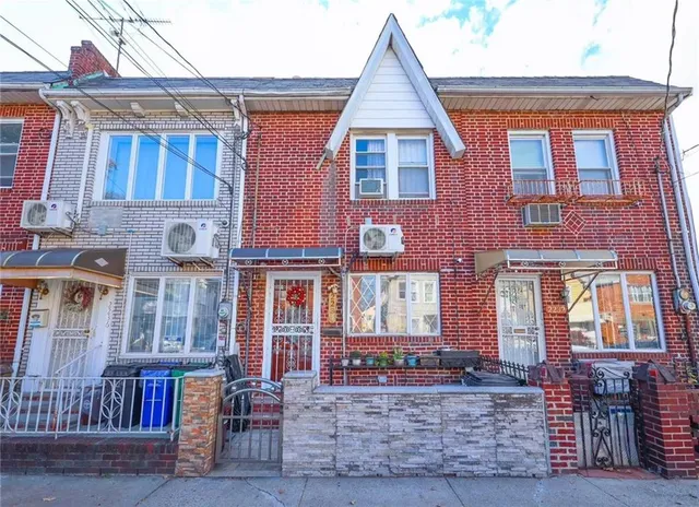 a view of a brick building with many windows