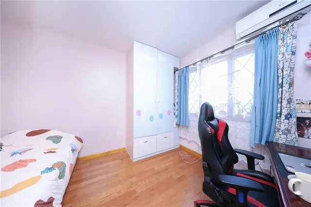 a view of a bedroom with a bed and furniture