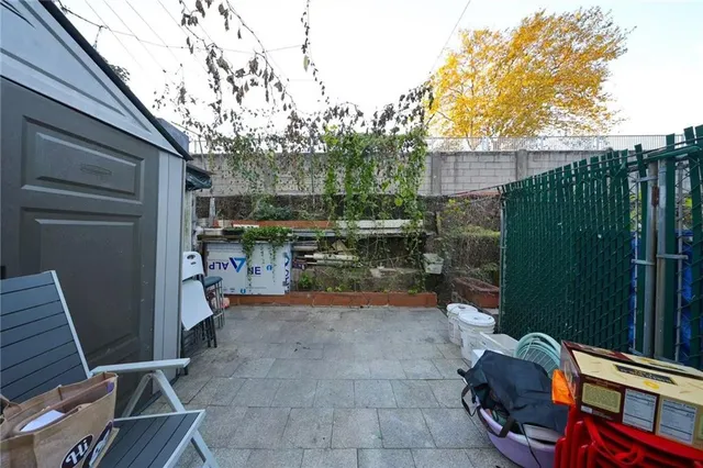 a view of a backyard with sitting area and garden