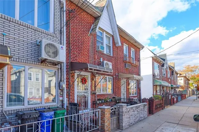 a front view of a brick building with many windows