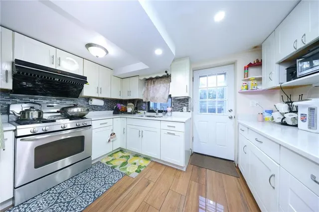 a kitchen with granite countertop appliances cabinets and a sink