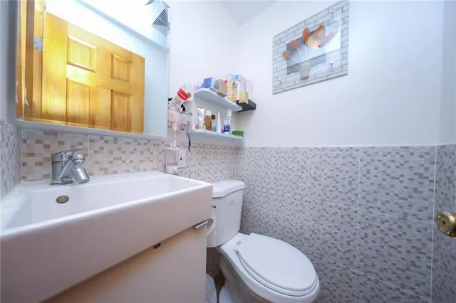 a bathroom with a sink a mirror and a toilet