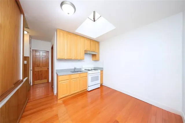 a kitchen with stainless steel appliances granite countertop a sink and a refrigerator