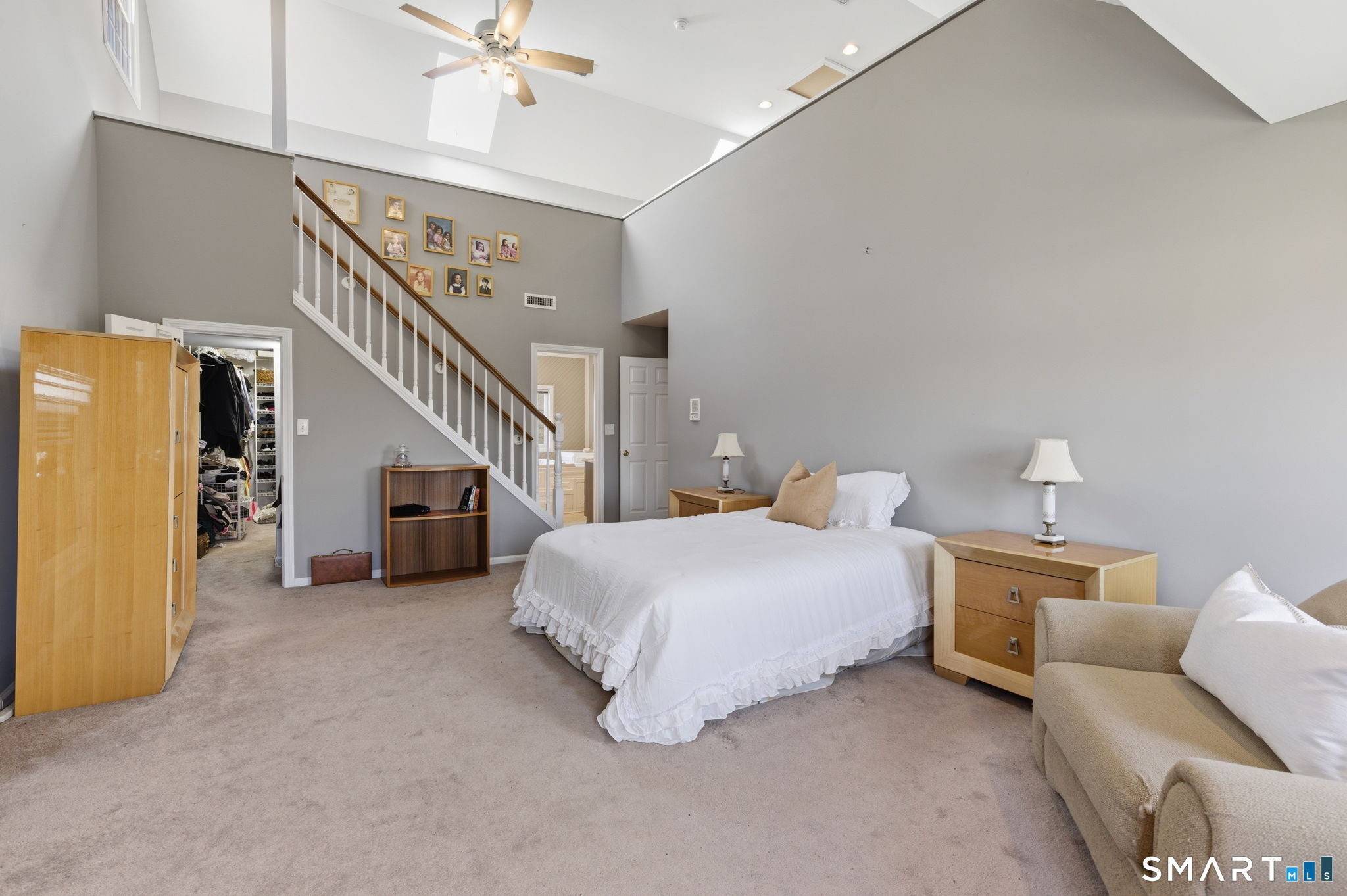 22 Misty Vale Road Newtown, CT 06482 - Photo 20 of 30 a bedroom with a bed and a chandelier
