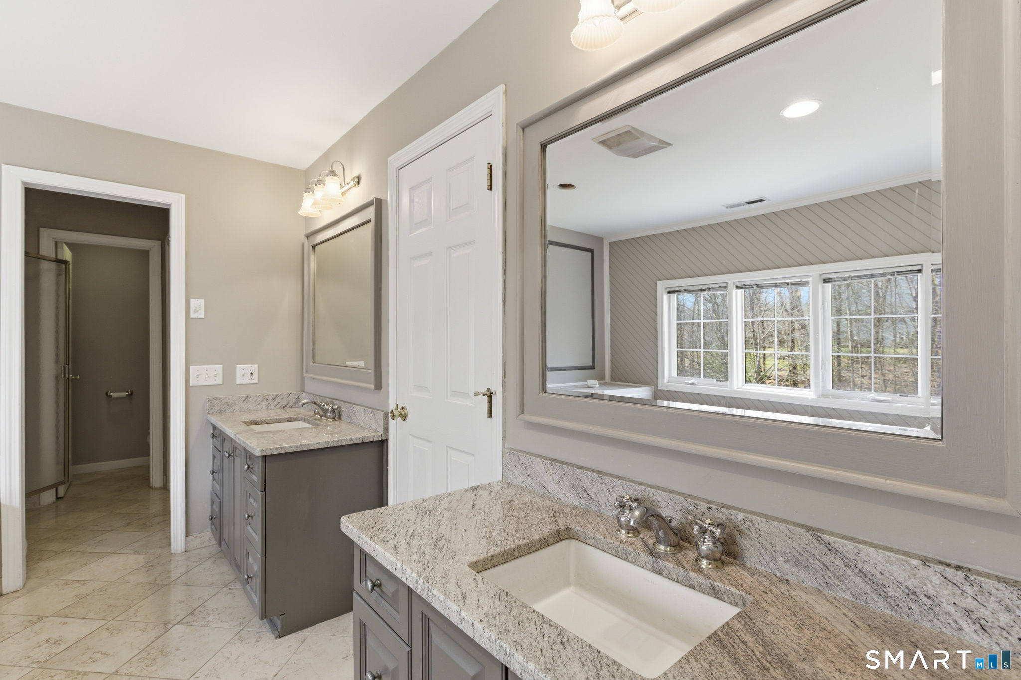 22 Misty Vale Road Newtown, CT 06482 - Photo 22 of 30 a bathroom with a granite countertop sink a large mirror and a bathtub
