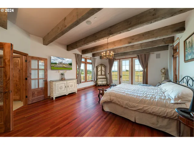 a spacious bathroom with a granite countertop sink a mirror and a bathtub