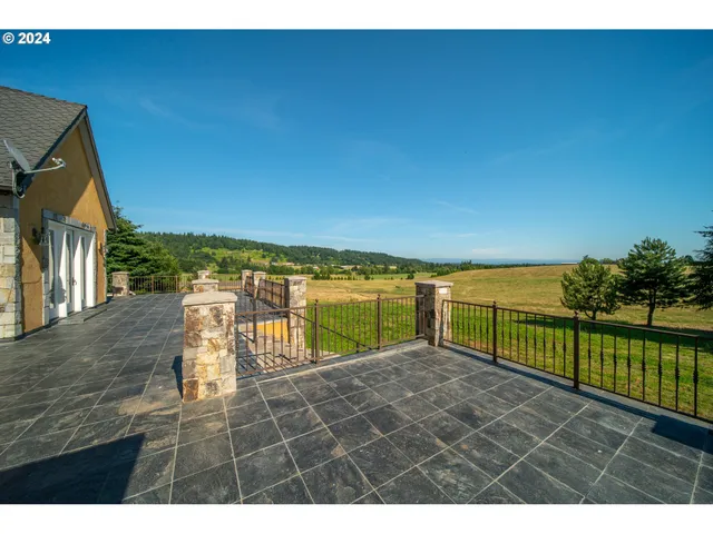 a view of house with a big yard and potted plants