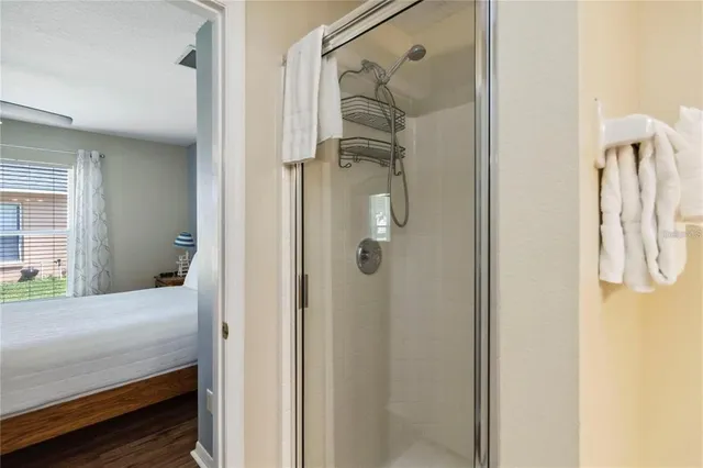 a bedroom with a bed and a shower