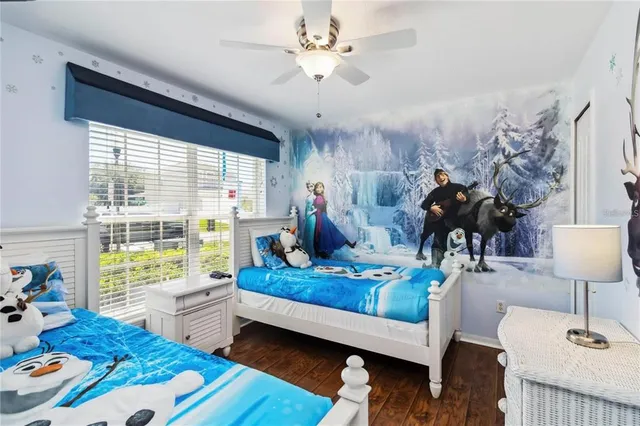 a bedroom with furniture and a wooden floor