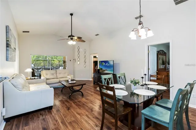 a view of a dining room with furniture wooden floor and chandelier