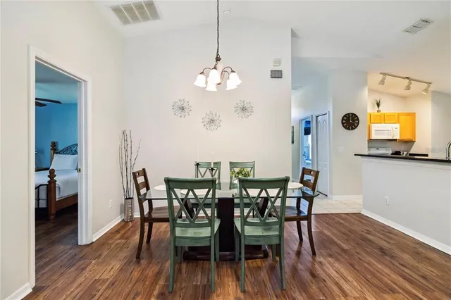a view of a dining room with furniture and wooden floor