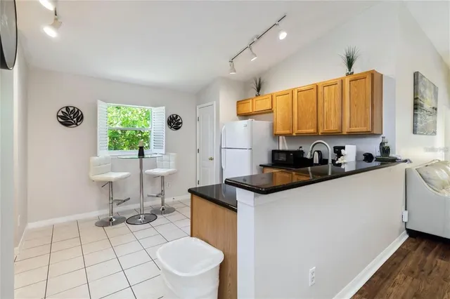 a kitchen with a sink a stove a window and a table