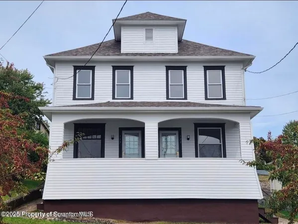 a white building with a window and balcony