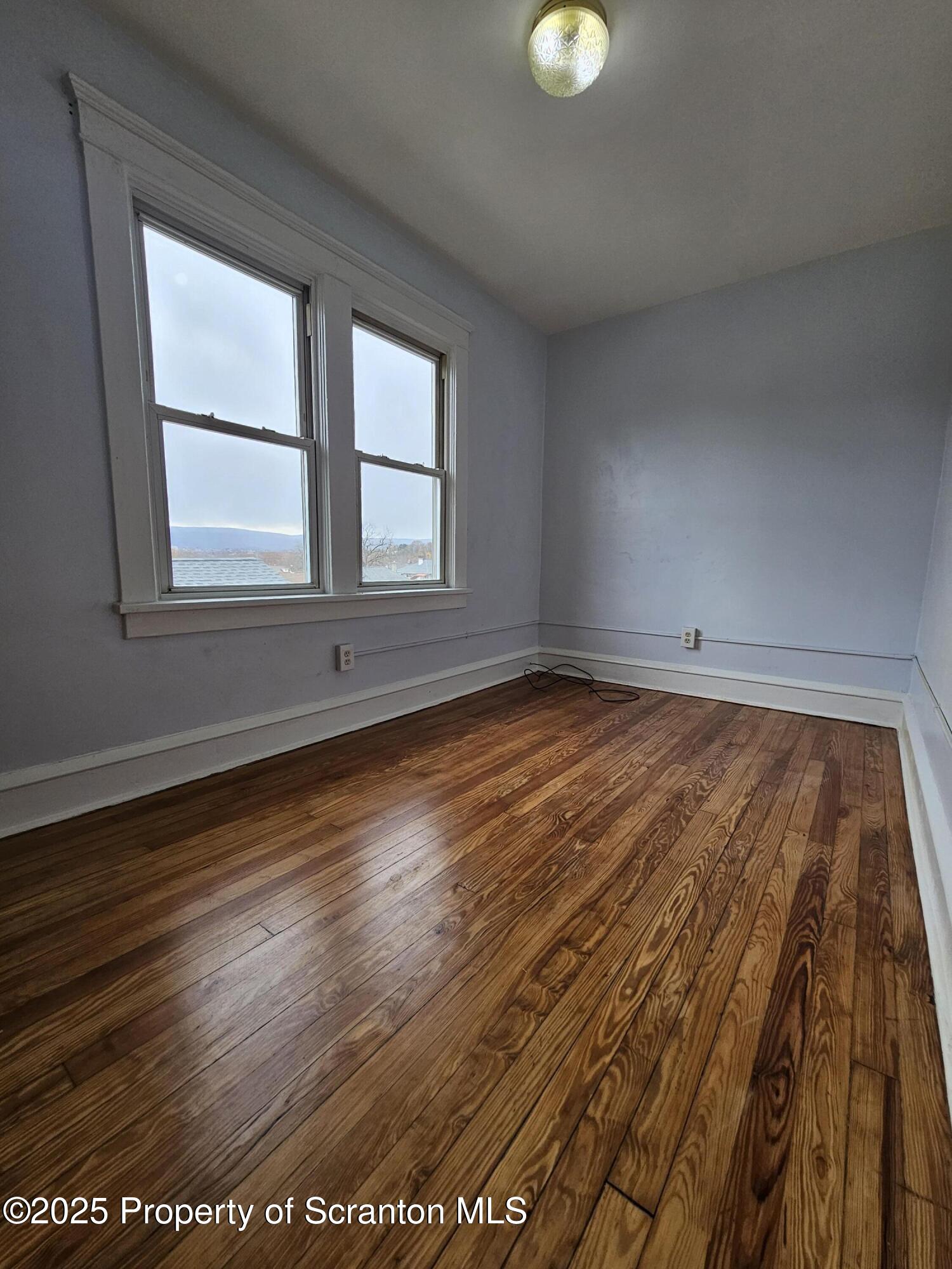 775 Bennett Street Luzerne, PA 18709 - Photo 12 of 18 an empty room with wooden floor and windows