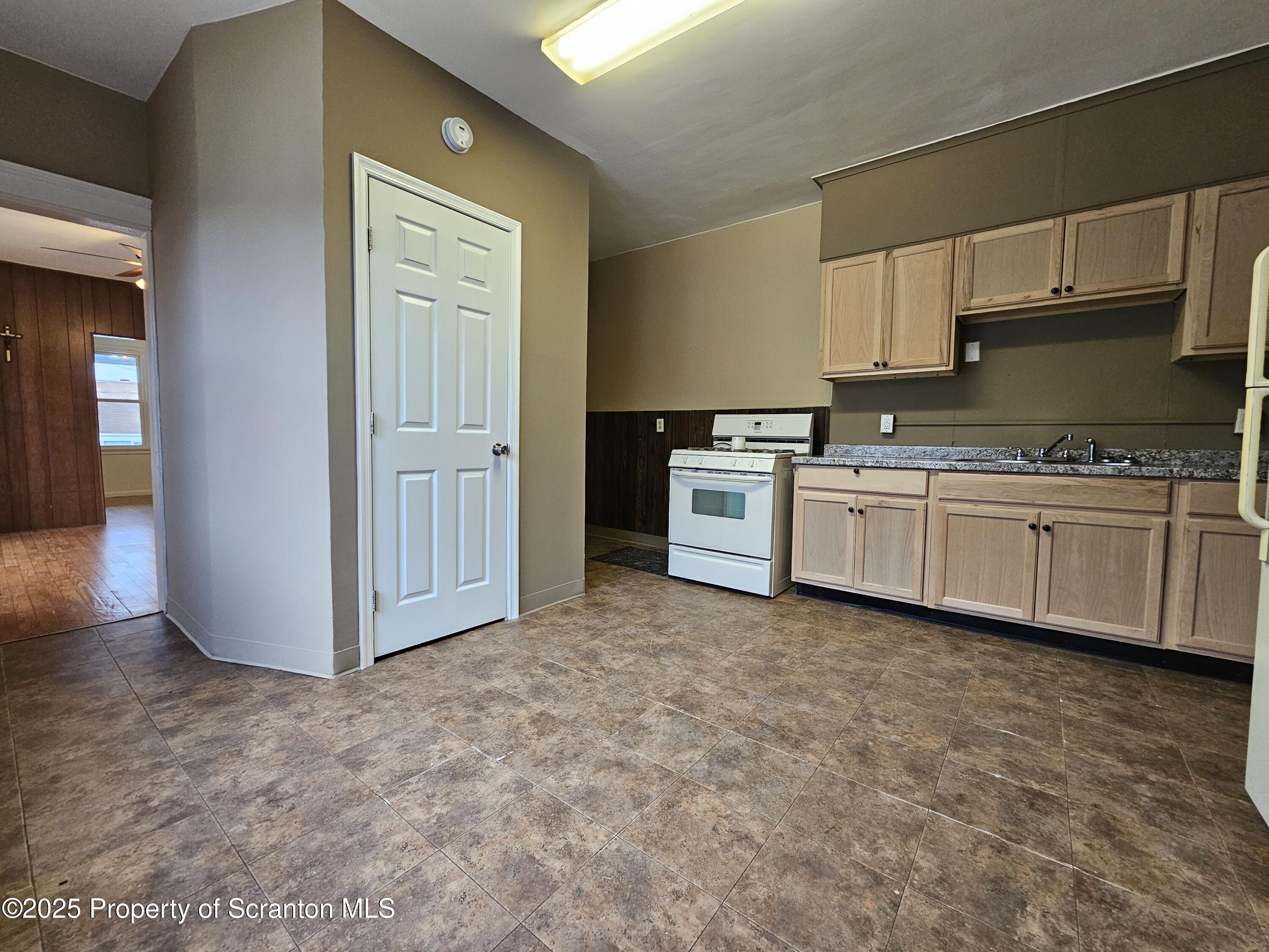 775 Bennett Street Luzerne, PA 18709 - Photo 5 of 18 a kitchen with stainless steel appliances granite countertop a stove a sink and a refrigerator