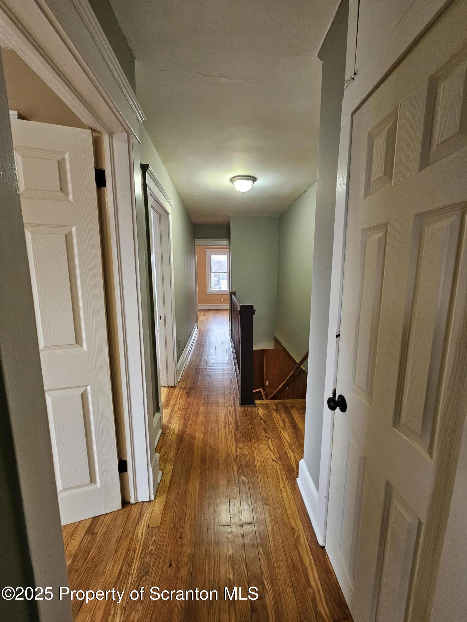 775 Bennett Street Luzerne, PA 18709 - Photo 9 of 18 a view of a hallway with wooden floor and staircase