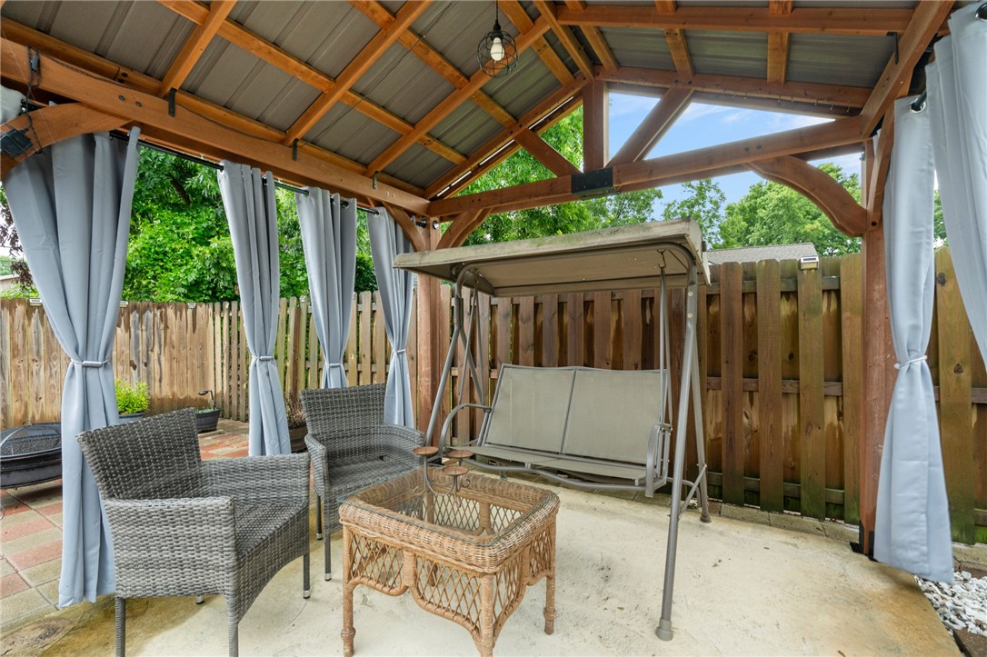 624 Locke Street Alma, AR 72921 - Photo 32 of 32 Outdoor patio featuring a wood-framed pergola with a metal roof and privacy curtains