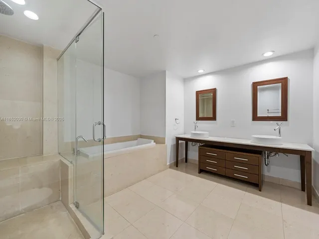 a spacious bathroom with a tub and a sink