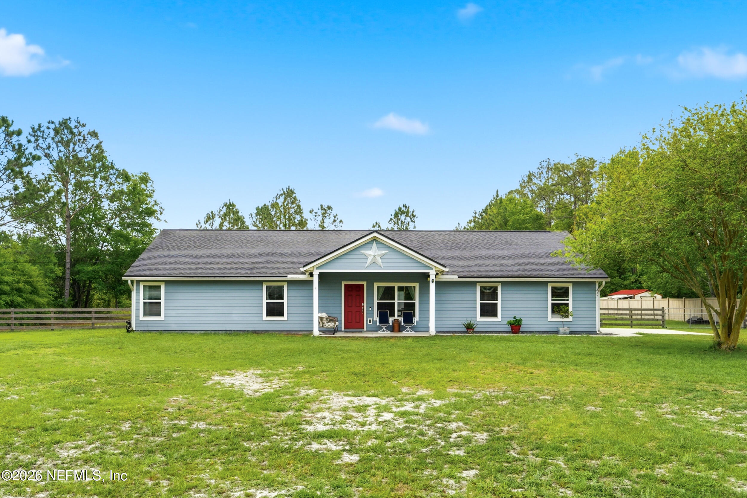 2471 Iris Street Middleburg, FL 32068 - Photo 1 of 40 a front view of a house with a garden