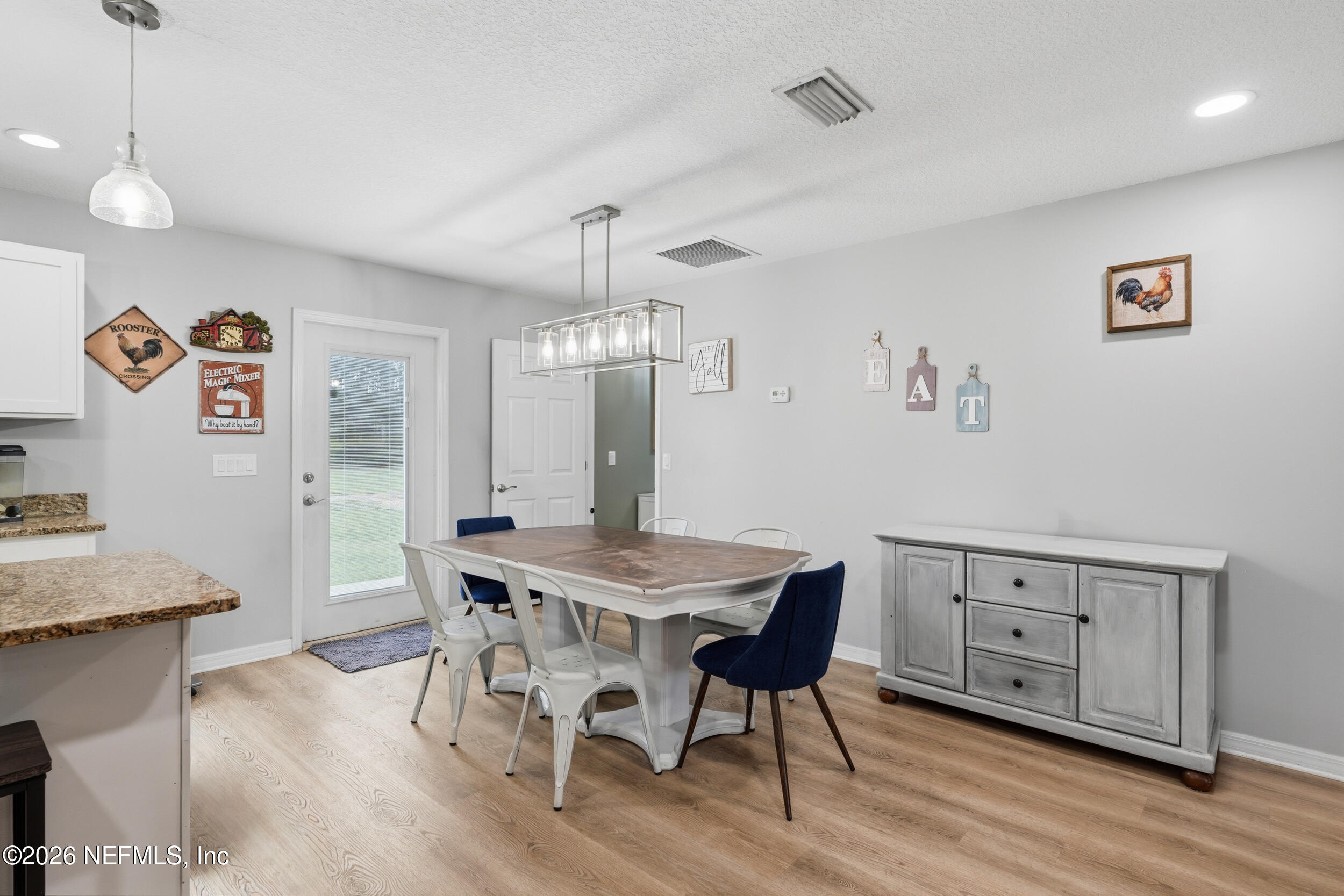 2471 Iris Street Middleburg, FL 32068 - Photo 11 of 40 a view of a dining room with furniture and wooden floor