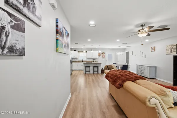 a living room with furniture and a chandelier