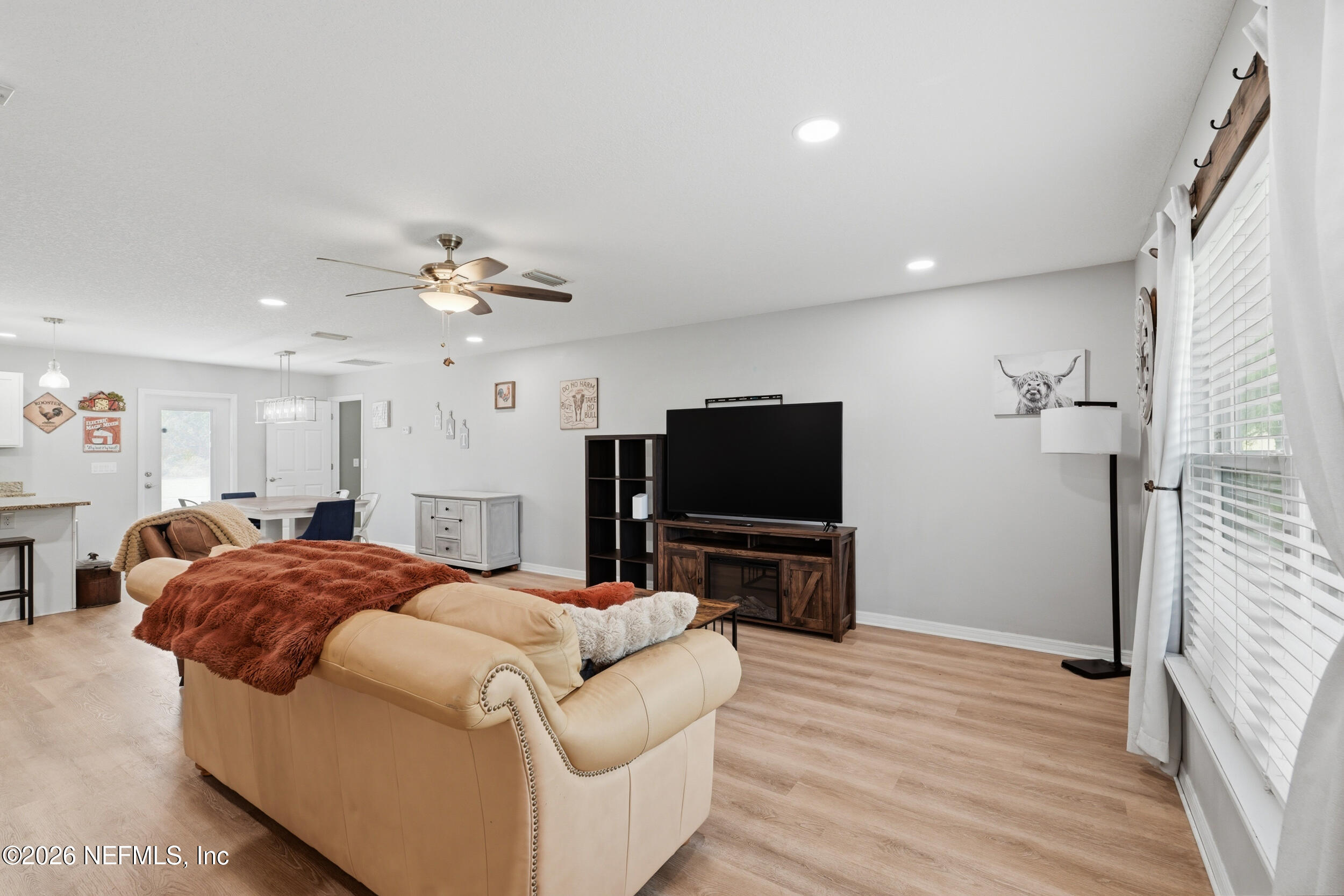 2471 Iris Street Middleburg, FL 32068 - Photo 16 of 40 a bedroom with a bed and a flat screen tv