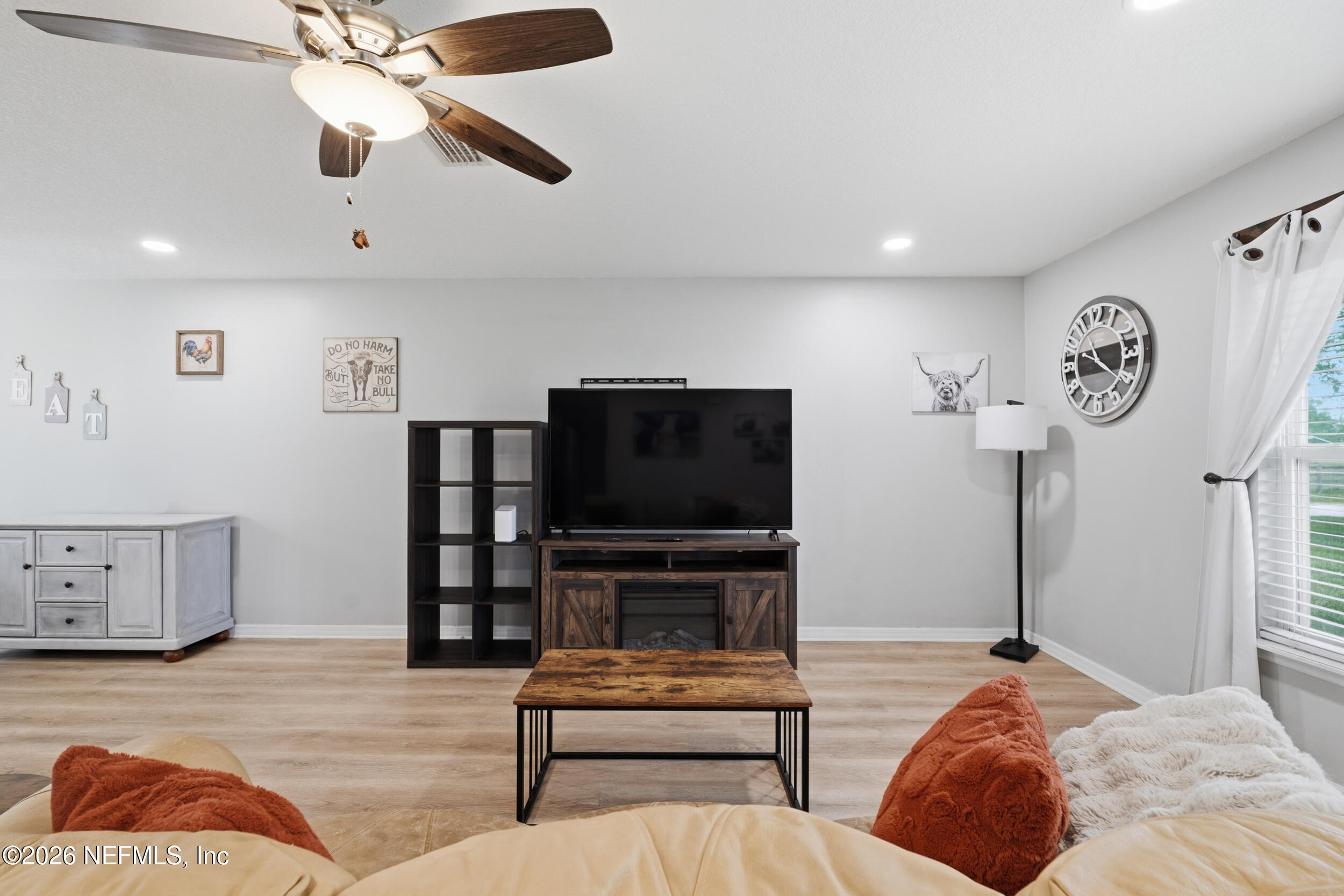 2471 Iris Street Middleburg, FL 32068 - Photo 17 of 40 a bedroom with furniture and a flat screen tv